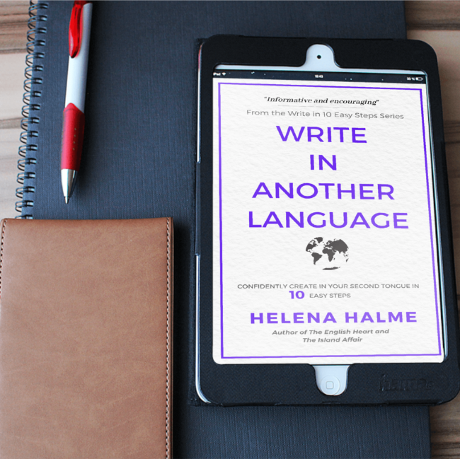 E-reader displaying a book cover with 'Write in Another Language' by Helena Halme, next to a pen and notebook on a wooden surface.