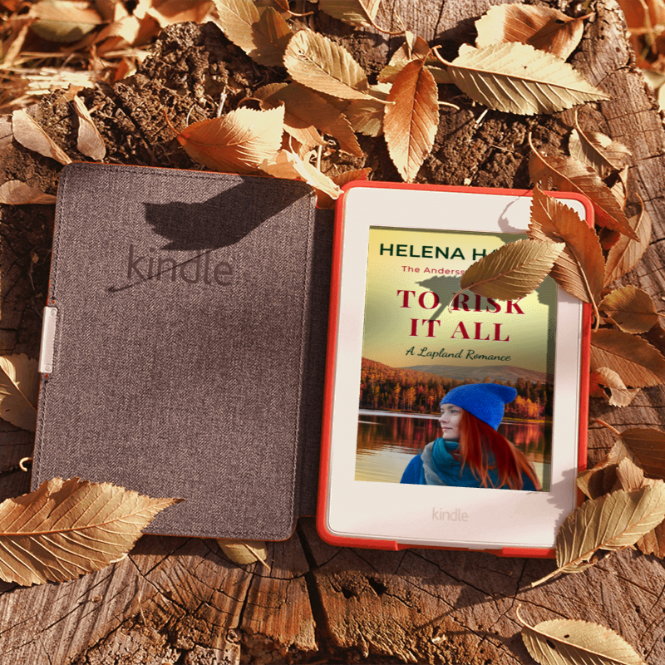 Kindle device with a book cover on a wooden surface with leaves